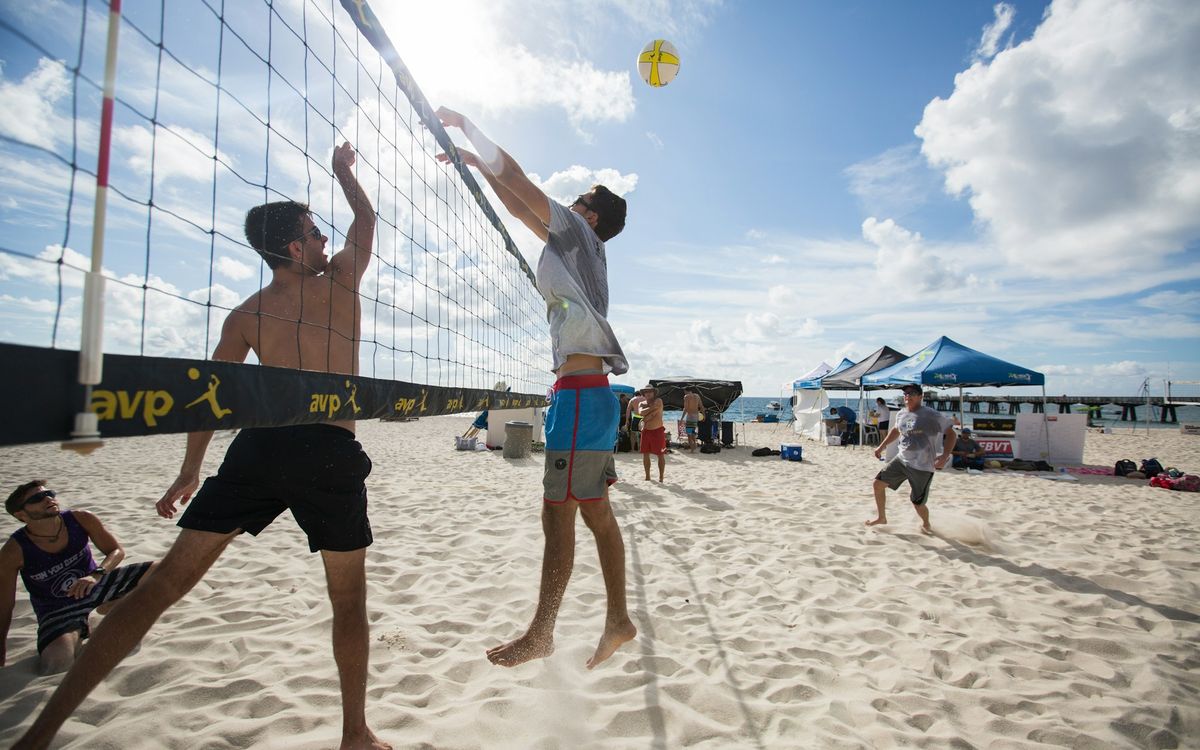 A beach volleyball game on the sand at Pompano Beach