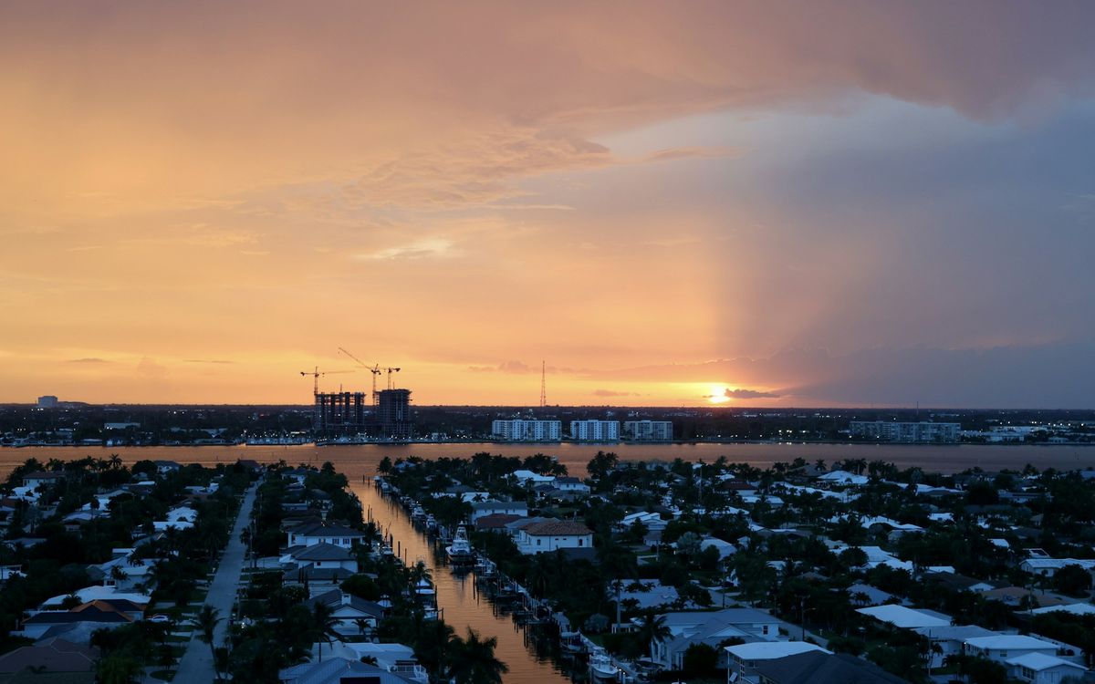 Sunset over Riviera Beach rooftops and the water beyond