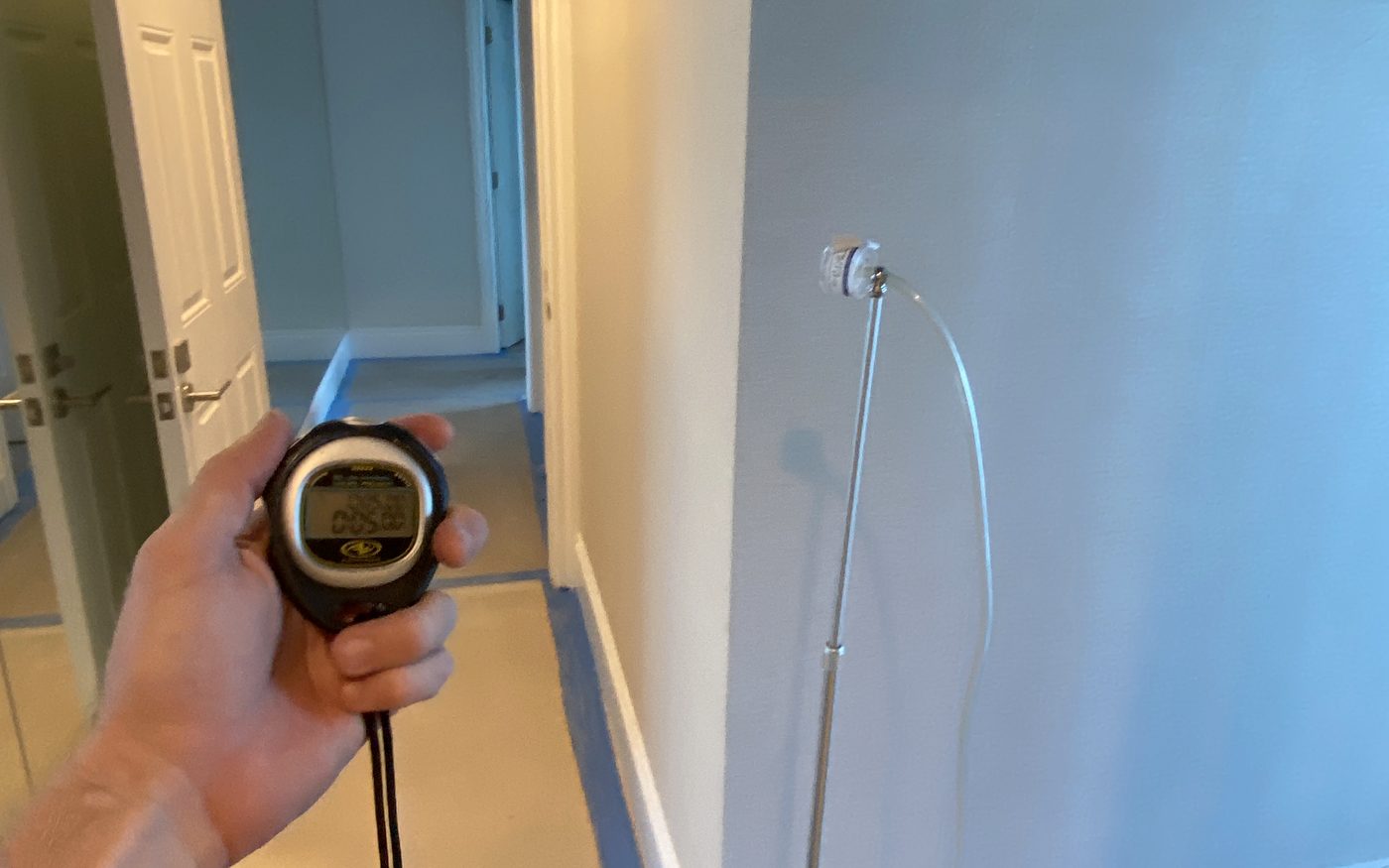 Air sampling stand and stopwatch running inside a sealed off hallway