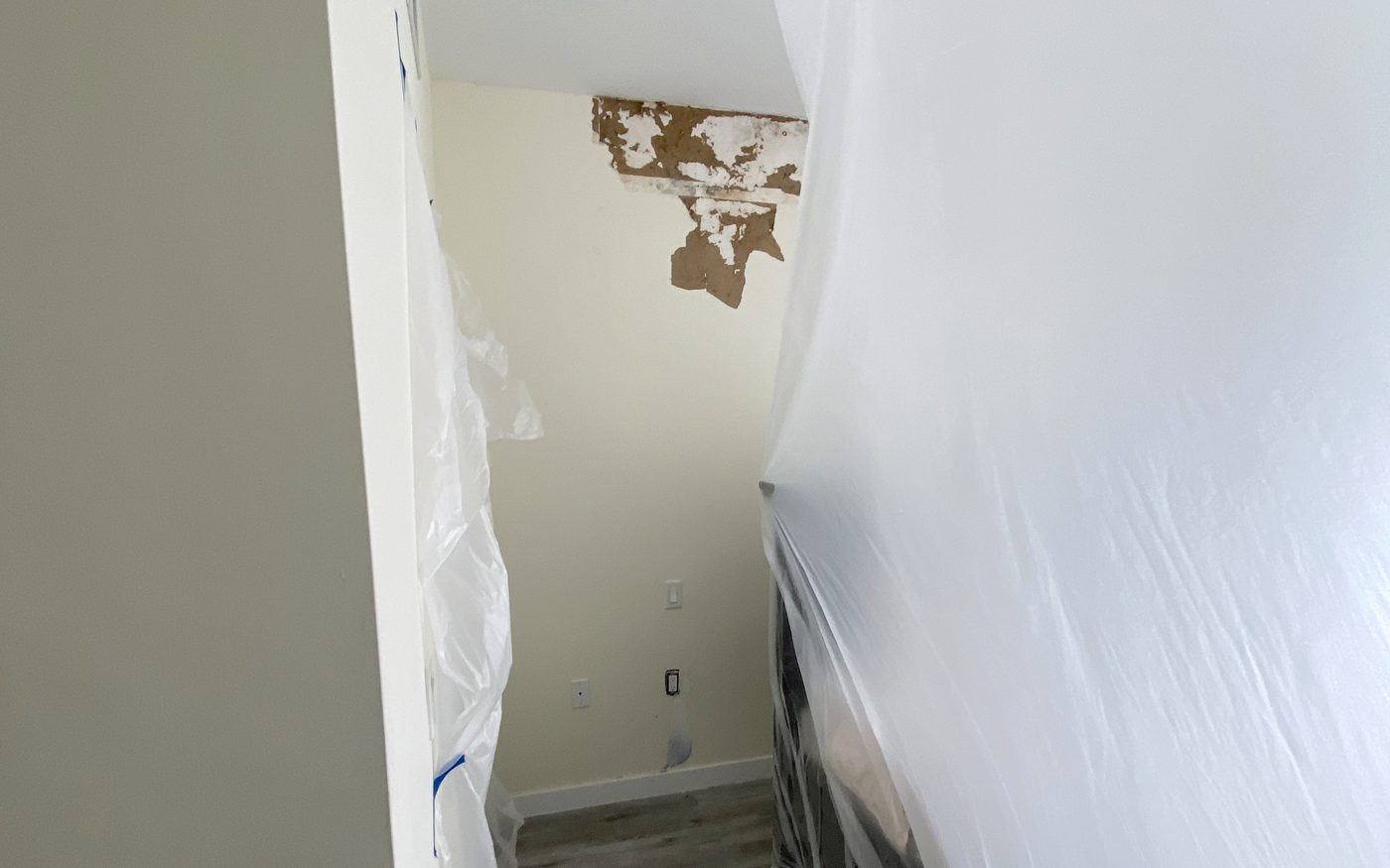 Containment sheeting still sealing a hallway while clearance testing is carried out