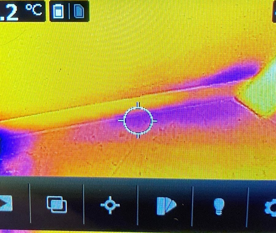 Thermal image showing a cool moisture plume spreading across a ceiling.