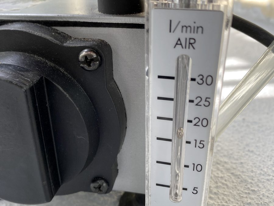 Flow meter on an air sampling pump showing the calibrated litres per minute rate